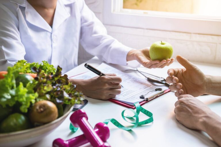 doctor filling out form with patient holding apple 1 768x512